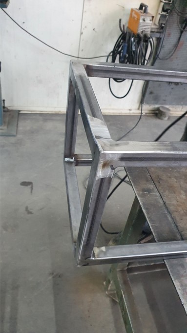 Close-up of the raw welded steel frame before finishing