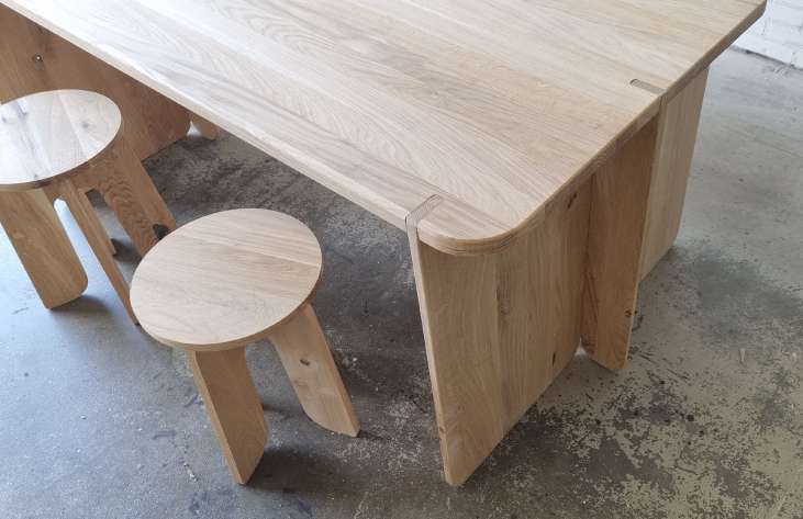 The built oak prototype of the Japandi table with stools