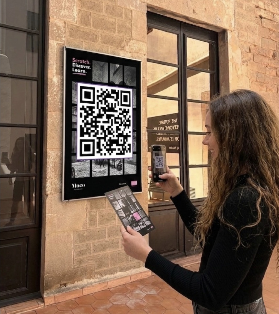 A visitor scans the QR code poster at the upstairs courtyard